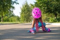 Girl fell while roller skating and is trying to get to her feet on her own Royalty Free Stock Photo