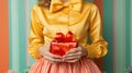 A girl in a festive bright dress holds a gift box in her hands, wrapping paper and ribbons shimmer with candy shades