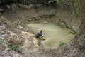 Girl fetches Unhygienic drinking water from a well Royalty Free Stock Photo