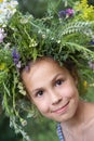 Girl in field flower garland Royalty Free Stock Photo