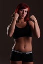 Young strong woman on a dark background Royalty Free Stock Photo