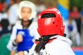 Girl fighting on stage during Taekwondo contest