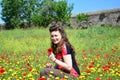 Girl in fild of wild flowers (poppy and calendula) Royalty Free Stock Photo