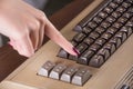 Girl finger push button on old computer keyboard Royalty Free Stock Photo