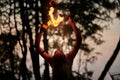 Girl fire dancing performance at outdoor art festival, smooth movements of female artist Royalty Free Stock Photo