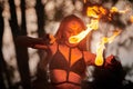 Girl fire dancing performance at outdoor art festival, smooth movements of female artist