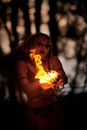 Girl fire dancing performance at outdoor art festival, smooth movements of female artist Royalty Free Stock Photo