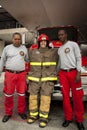 Girl in fireproof suit with 2 firemen
