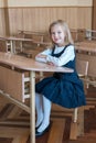 Girl in the first grade, is sitting at the desk