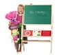 Girl on first school day stands beside chalk board Royalty Free Stock Photo