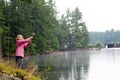 Girl fishing on the bank of a lake Royalty Free Stock Photo