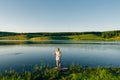 girl fishing at lake in summer vacation on sunset