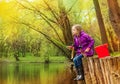 Girl fishing near beautiful pond with fishrod Royalty Free Stock Photo