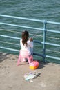 Girl fishing on a pier