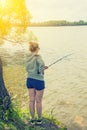 Girl with fishing rod fishing in the pond Royalty Free Stock Photo