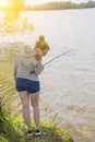 Girl with fishing rod fishing in the pond Royalty Free Stock Photo