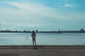 Girl fishing in the seaside port