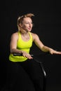 Girl on a fitness trampoline on a black background in a yellow t-shirt jump, fun exercise fitness lifestyle leap, weight Royalty Free Stock Photo