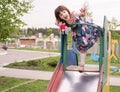 Girl five years on a children`s slide for a walk in the evening Royalty Free Stock Photo