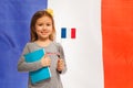 Girl with flag and book against French banner Royalty Free Stock Photo