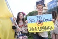 Girl with a flag and woman with a sign calling for a ban on flying over Ukraine