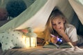 Girl with flashlight reading book Royalty Free Stock Photo