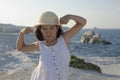 Girl flexing muscles on beach