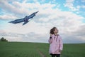 A girl flies a kite on a large green field. Blue cloudy sky at Royalty Free Stock Photo