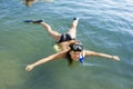 Girl in Flipper lying on the Sea Royalty Free Stock Photo