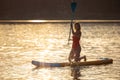 Girl floating on supboard on a river or lake. Royalty Free Stock Photo