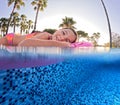 Girl floats on pink inflatable in the pool. Beach resort vacation by the sea. Winter and summer seaside resort holidays Royalty Free Stock Photo