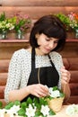 Girl florist collects a bouquet artificial flowers and soap Royalty Free Stock Photo