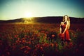 Girl in a flourishing field. fashion portrait of a sensual girl. opium, woman or happy girl in field of poppy seed Royalty Free Stock Photo