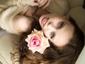 Girl with flower. Beautiful young woman holding red rose and smiling Royalty Free Stock Photo