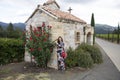 A girl with flower standing by the church Royalty Free Stock Photo