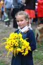 Girl with flowers in uniform first time goes to school. beginning of school year