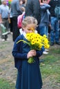 Girl with flowers in uniform first time goes to school. beginning of school year Royalty Free Stock Photo