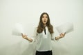 Girl with flowing hair stands in the center of the frame, holding white sheets in her hands and is very surprised