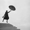 Girl flying away on umbrella