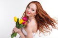 Girl with flying hair is holding colorful tulips Royalty Free Stock Photo