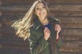 Girl with flying hair near wooden wall Royalty Free Stock Photo