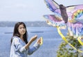 Girl flying kite by the lake Royalty Free Stock Photo