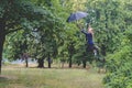 The girl is flying with an umbrella. Postprocessing Royalty Free Stock Photo