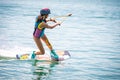 Girl focused on wakeboarding on a lake