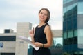 Girl with a folder for papers in her hands cheerfully laughs