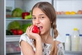 Girl with food near fridge Royalty Free Stock Photo