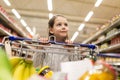 Girl with food in shopping cart at grocery store Royalty Free Stock Photo