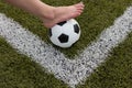 Girl foot on the soccer ball on green field Royalty Free Stock Photo