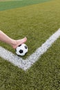 Girl foot on the soccer ball on green field Royalty Free Stock Photo