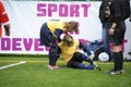 Girl football player helping her injured teammate. Football Girls Ukraine Cup EmPower Girl . Kyiv, Ukraine